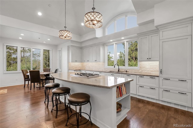 917 Dakota Dr, Castle Rock, CO 80108 - kitchen featuring a kitchen island, recessed lighting, healthy amount of natural light, and light stone counters