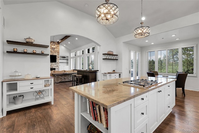 917 Dakota Dr, Castle Rock, CO 80108 - kitchen featuring open shelves, stainless steel gas stovetop, arched walkways, healthy amount of natural light, and recessed lighting