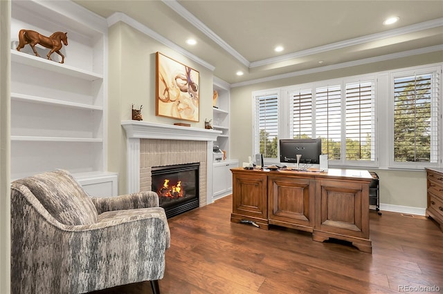 917 Dakota Dr, Castle Rock, CO 80108 - home office featuring dark wood-style floors, a tile fireplace, crown molding, built in features, and recessed lighting