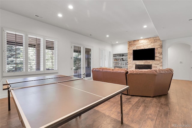 917 Dakota Dr, Castle Rock, CO 80108 - rec room featuring wood finished floors, recessed lighting, a stone fireplace, and arched walkways