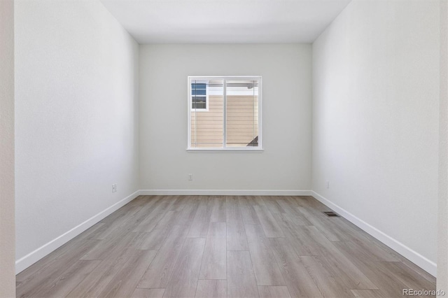 spare room with light hardwood / wood-style flooring