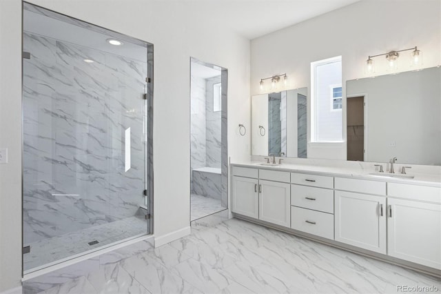 bathroom featuring tiled shower and vanity