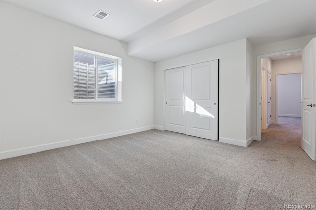 unfurnished bedroom with a closet and carpet flooring