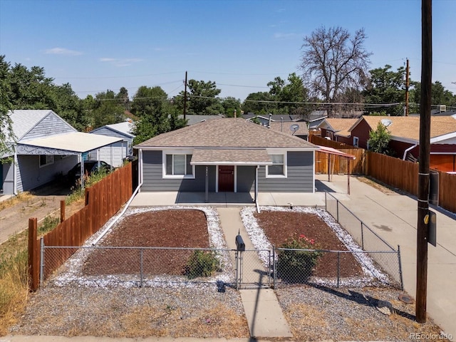3971 W Kentucky Ave, Denver, CO 80219 - view of front of property featuring roof with shingles, a fenced front yard, a porch, and a gate