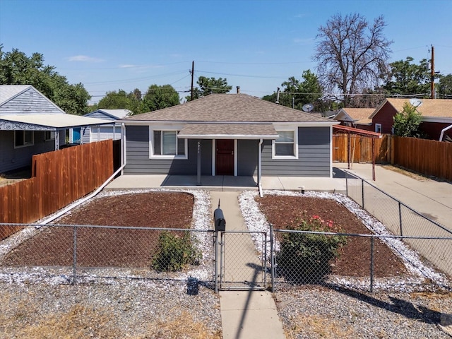 3971 W Kentucky Ave, Denver, CO 80219 - view of front of property featuring covered porch, a gate, a fenced front yard, and roof with shingles