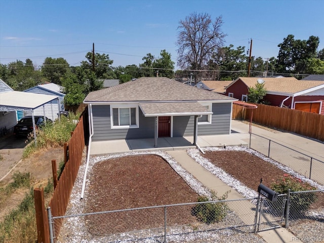 3971 W Kentucky Ave, Denver, CO 80219 - view of front of property featuring a fenced backyard, roof with shingles, and a porch