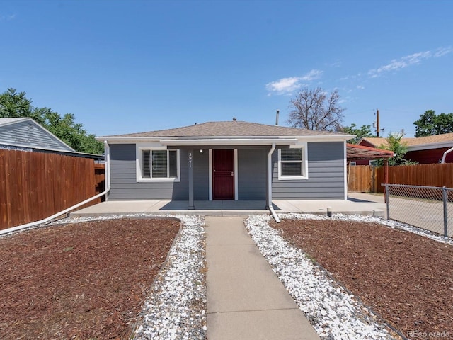 3971 W Kentucky Ave, Denver, CO 80219 - view of front of home featuring covered porch, roof with shingles, and a patio area