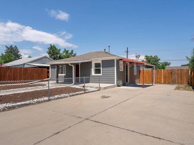 3971 W Kentucky Ave, Denver, CO 80219 - ranch-style home featuring concrete driveway, a carport, and covered porch