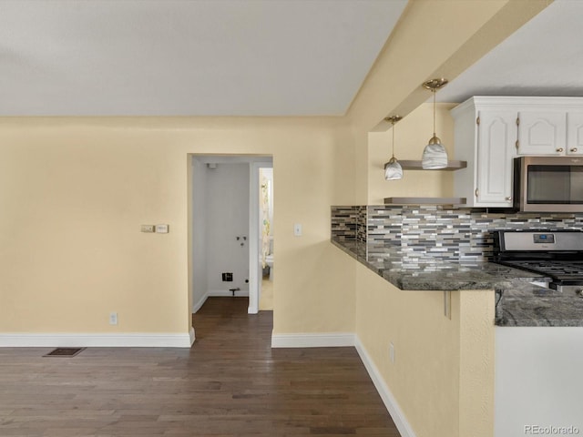 3971 W Kentucky Ave, Denver, CO 80219 - kitchen featuring stainless steel appliances, white cabinets, dark wood-style flooring, decorative backsplash, and decorative light fixtures