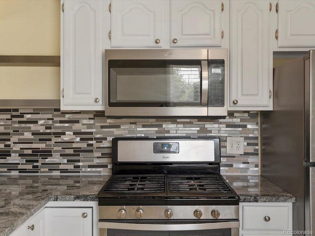 3971 W Kentucky Ave, Denver, CO 80219 - kitchen with stainless steel appliances, white cabinets, backsplash, and dark stone counters