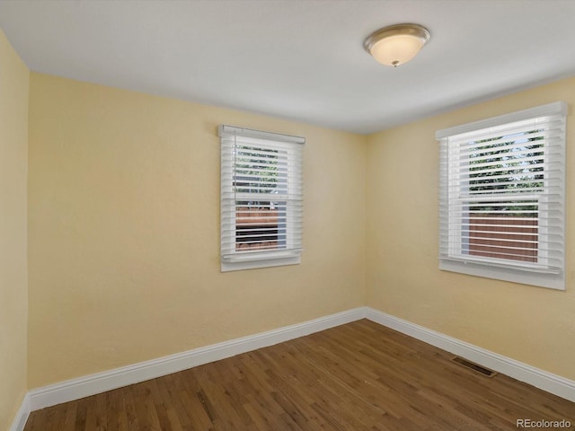 3971 W Kentucky Ave, Denver, CO 80219 - unfurnished room featuring wood finished floors and plenty of natural light