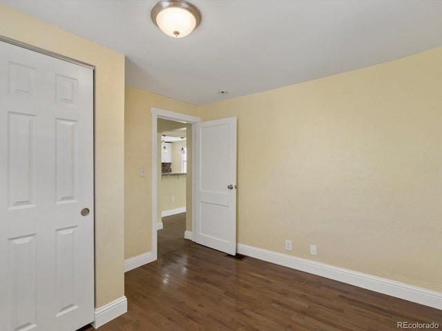 3971 W Kentucky Ave, Denver, CO 80219 - unfurnished bedroom with dark wood finished floors and baseboards