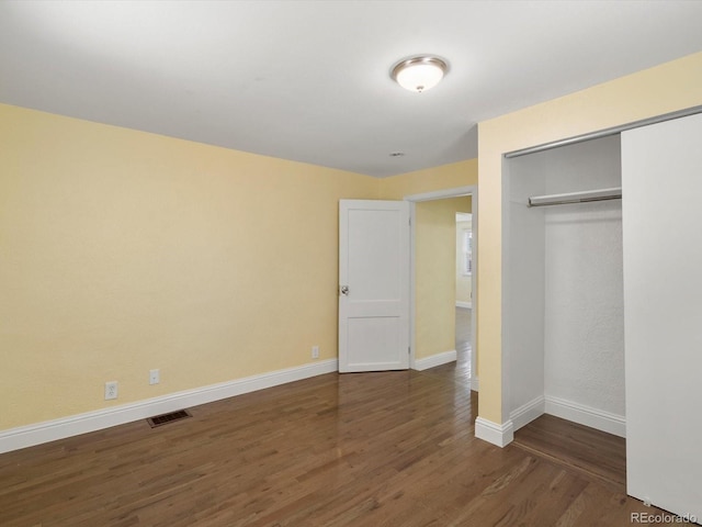 3971 W Kentucky Ave, Denver, CO 80219 - unfurnished bedroom with dark wood-type flooring and a closet