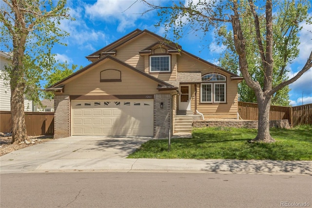 split level home with brick siding, concrete driveway, and a garage