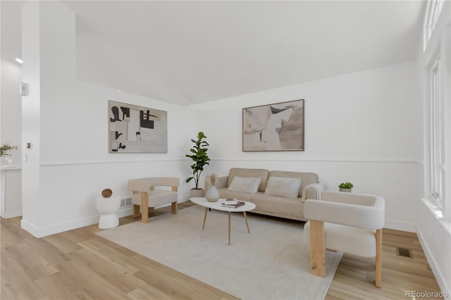 living area with wood finished floors and baseboards