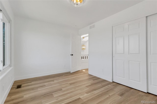 unfurnished bedroom featuring light wood finished floors and baseboards