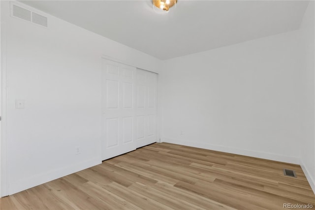 unfurnished room with light wood-style floors and baseboards