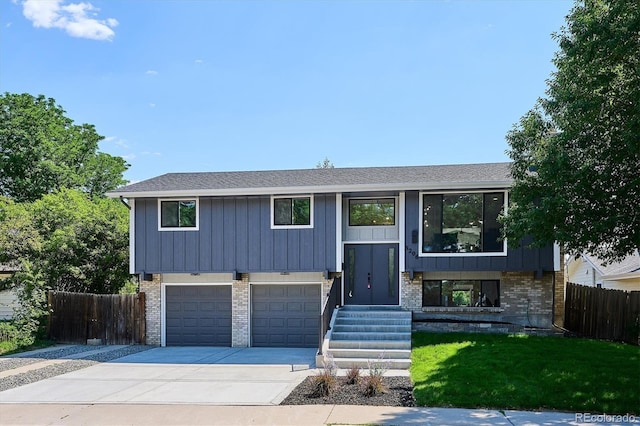 3206 S Pontiac St, Denver, CO 80224 - split foyer home with brick siding, driveway, an attached garage, and board and batten siding