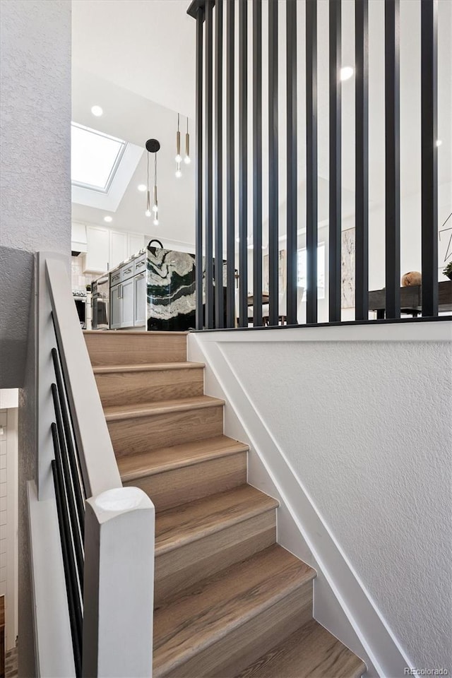 3206 S Pontiac St, Denver, CO 80224 - staircase with a skylight, a textured wall, and recessed lighting