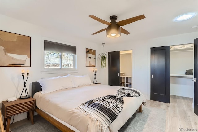 bedroom with ceiling fan and light hardwood / wood-style flooring