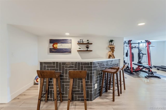 bar with light wood-type flooring