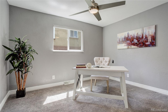 carpeted home office featuring ceiling fan