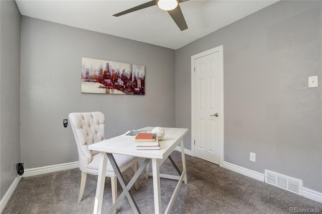 office area with ceiling fan and dark colored carpet