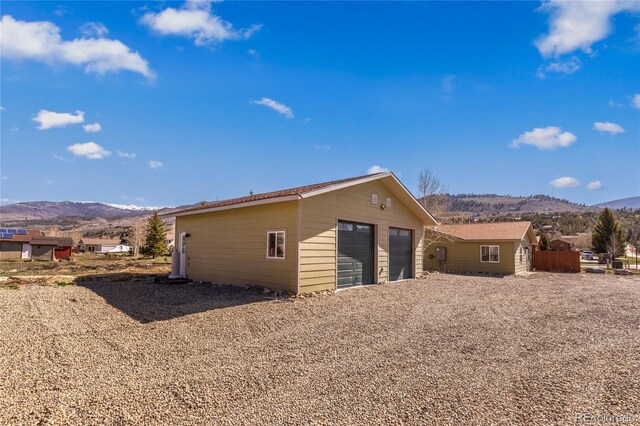840 Mesa Dr, Silverthorne, CO 80498 - back of property featuring a mountain view, a detached garage, and an outdoor structure