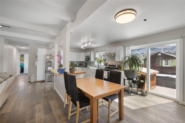 840 Mesa Dr, Silverthorne, CO 80498 - dining room featuring wood finished floors, beam ceiling, and baseboards