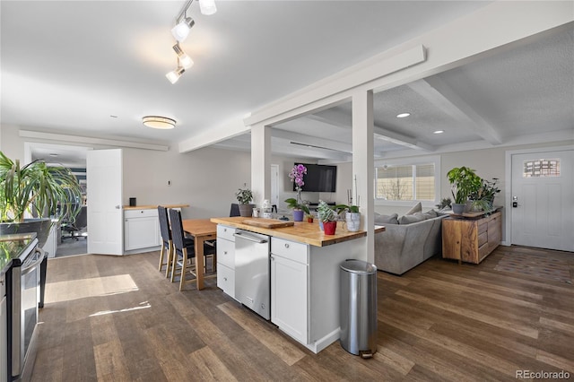 840 Mesa Dr, Silverthorne, CO 80498 - kitchen featuring wooden counters, beamed ceiling, stainless steel dishwasher, dark wood finished floors, and white cabinets