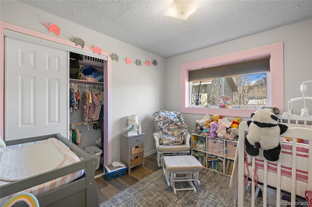 840 Mesa Dr, Silverthorne, CO 80498 - bedroom with wood finished floors, a textured ceiling, and a closet