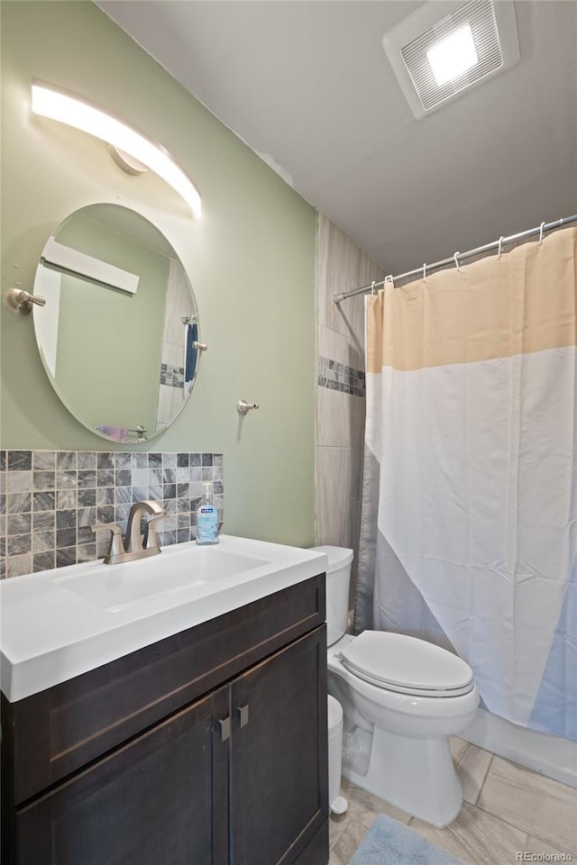 840 Mesa Dr, Silverthorne, CO 80498 - bathroom with toilet, vanity, tile patterned floors, tasteful backsplash, and curtained shower