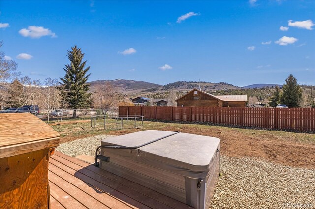840 Mesa Dr, Silverthorne, CO 80498 - wooden deck featuring a hot tub, a mountain view, and fence