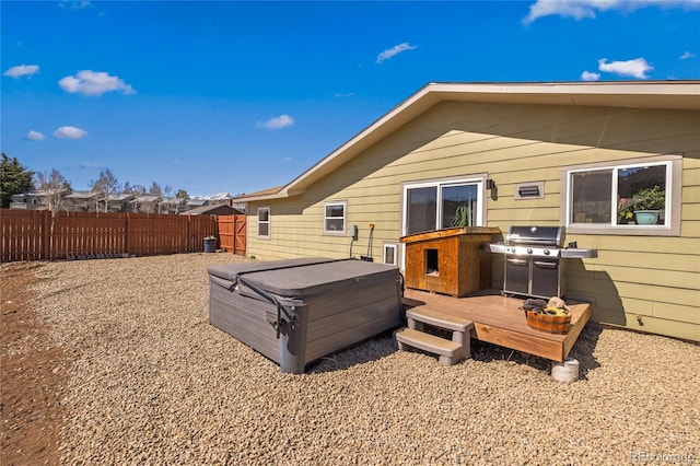 840 Mesa Dr, Silverthorne, CO 80498 - back of property featuring a hot tub, a fenced backyard, and a deck