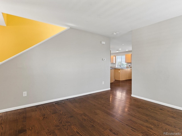 4816 S Elk Way, Aurora, CO 80016 - empty room with dark wood-style floors and baseboards
