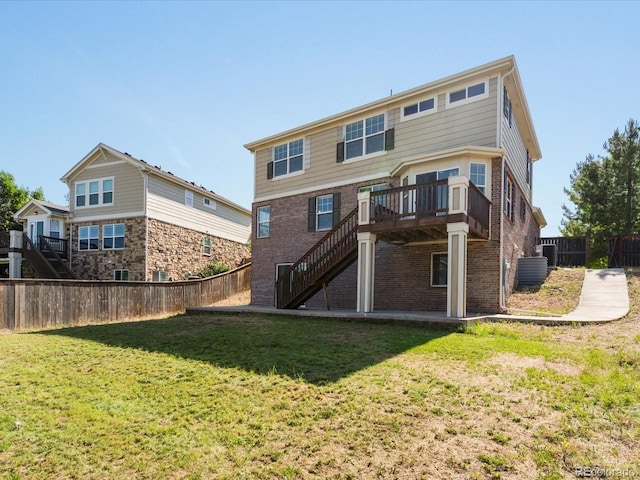 4816 S Elk Way, Aurora, CO 80016 - back of property with stairs, brick siding, a fenced backyard, and a wooden deck