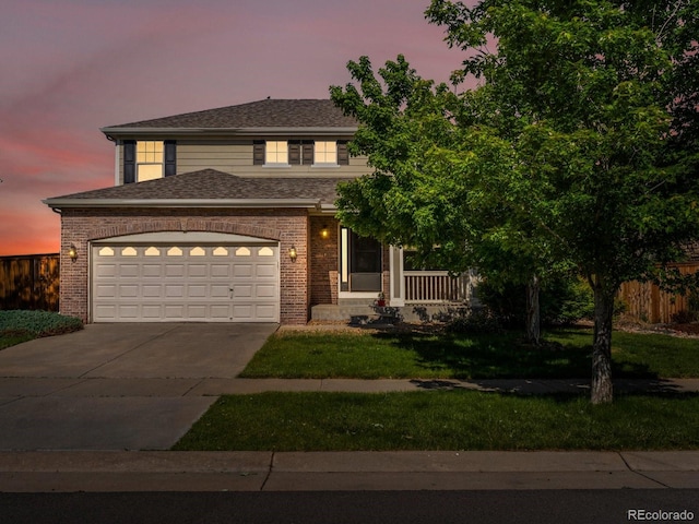 4816 S Elk Way, Aurora, CO 80016 - view of front of house featuring driveway, brick siding, a garage, and a porch