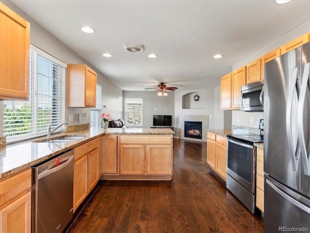 4816 S Elk Way, Aurora, CO 80016 - kitchen with appliances with stainless steel finishes, light brown cabinetry, open floor plan, a ceiling fan, and recessed lighting