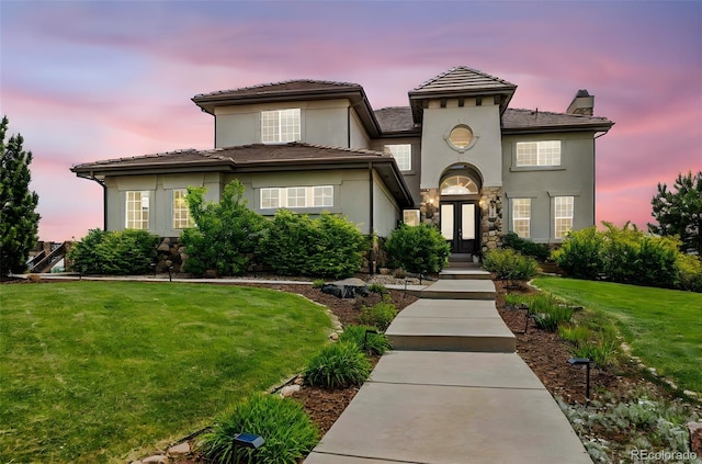 7724 Kryptonite Ln, Castle Rock, CO 80108 - view of front of house with french doors, a yard, a chimney, stucco siding, and stone siding