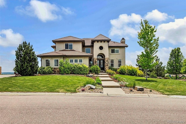 7724 Kryptonite Ln, Castle Rock, CO 80108 - mediterranean / spanish-style home featuring stucco siding, stone siding, a chimney, and a front yard