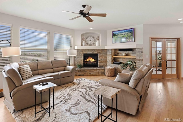 7724 Kryptonite Ln, Castle Rock, CO 80108 - living area with a stone fireplace, ceiling fan, and wood finished floors