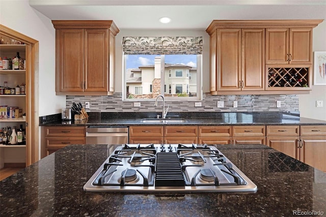 7724 Kryptonite Ln, Castle Rock, CO 80108 - kitchen with a sink, appliances with stainless steel finishes, tasteful backsplash, dark stone countertops, and recessed lighting