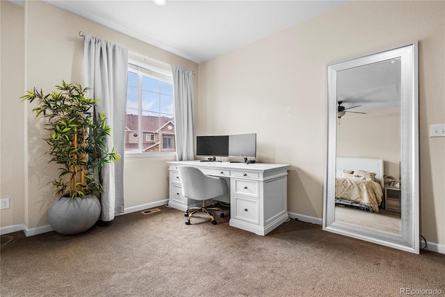office area with light colored carpet, a ceiling fan, and baseboards