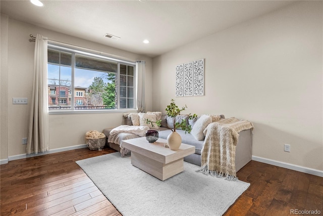 living room featuring hardwood / wood-style flooring, baseboards, and recessed lighting