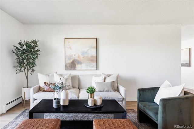 living room with baseboards, baseboard heating, and wood finished floors