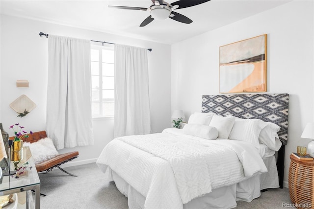 bedroom with ceiling fan, baseboards, and carpet flooring