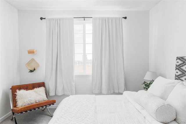carpeted bedroom featuring baseboards
