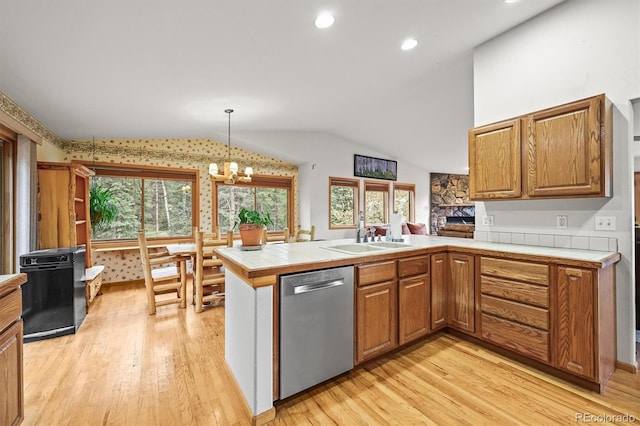 29825 Kennedy Gulch Rd, Conifer, CO 80433 - kitchen with dishwasher, tile countertops, a peninsula, light wood-type flooring, and vaulted ceiling