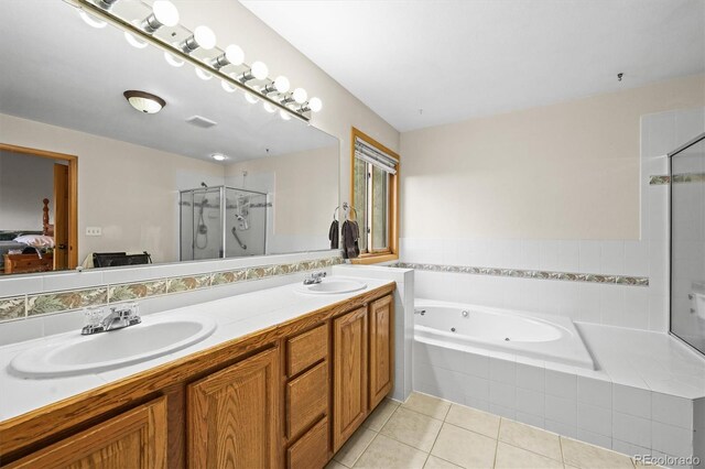 29825 Kennedy Gulch Rd, Conifer, CO 80433 - ensuite bathroom featuring tile patterned flooring, a stall shower, a jetted tub, and double vanity