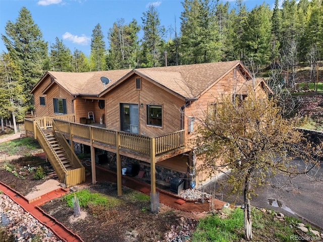 29825 Kennedy Gulch Rd, Conifer, CO 80433 - back of house with a deck, stairway, and roof with shingles